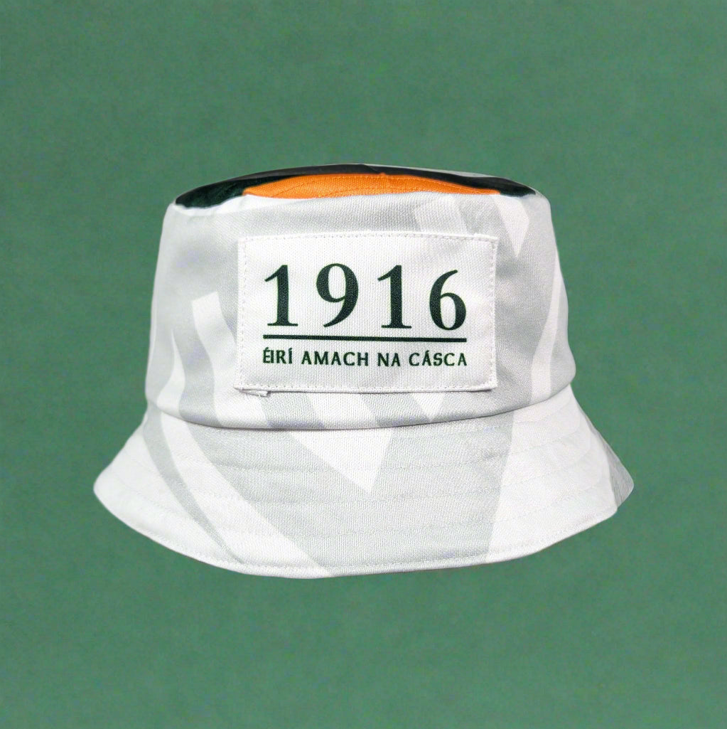 White bucket hat with a label reading '1916' held by a hand against a gray background