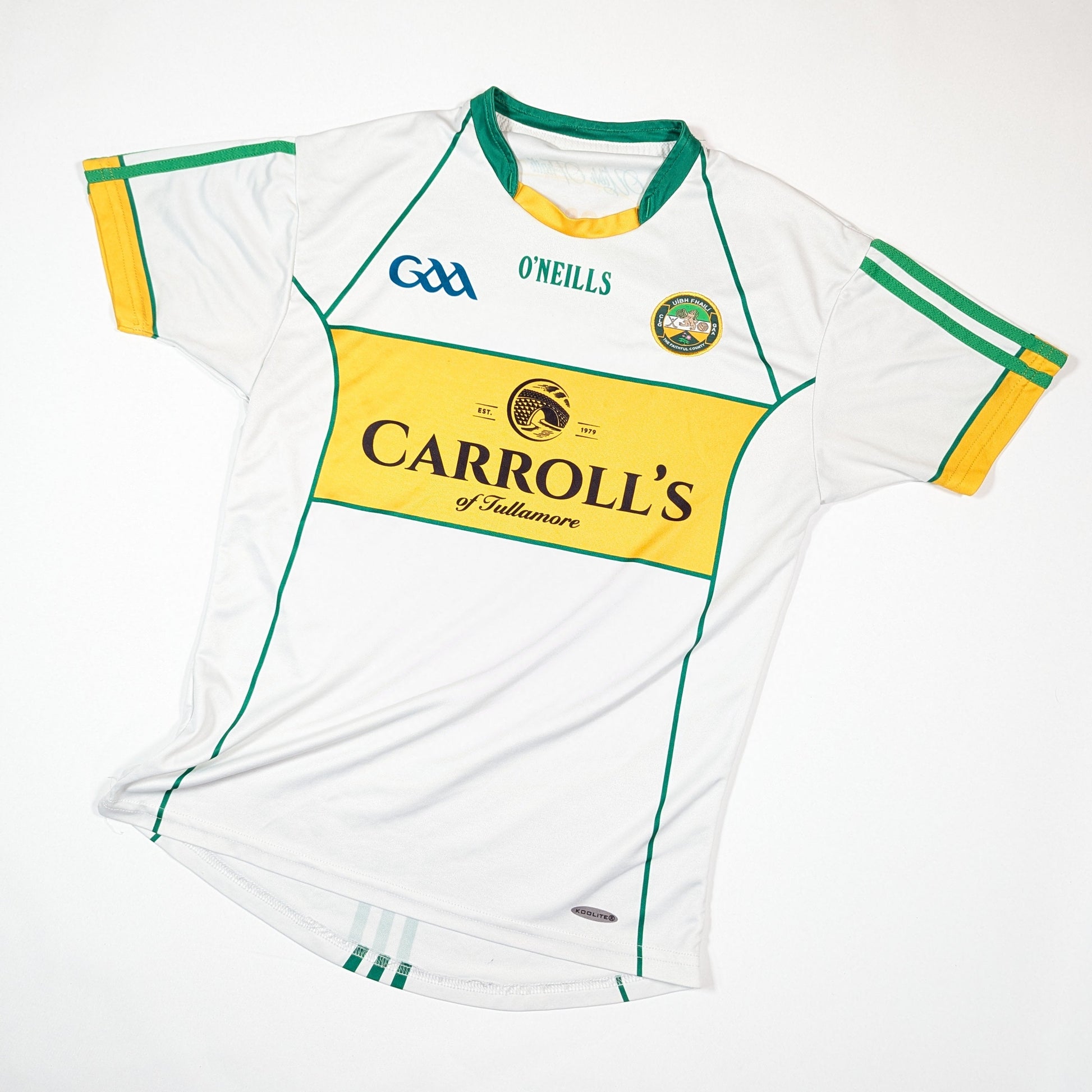 White sports jersey with green and yellow accents, featuring O'Neills and Carroll's logos on a white background.