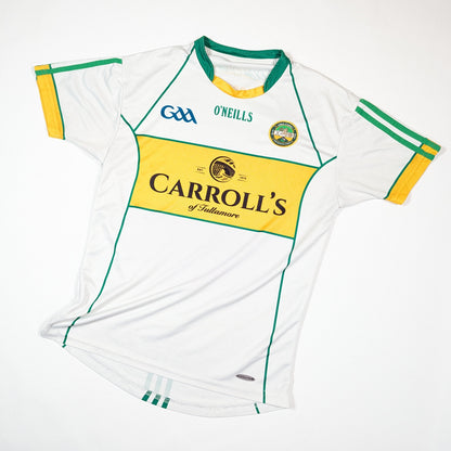 White sports jersey with green and yellow accents, featuring O'Neills and Carroll's logos on a white background.